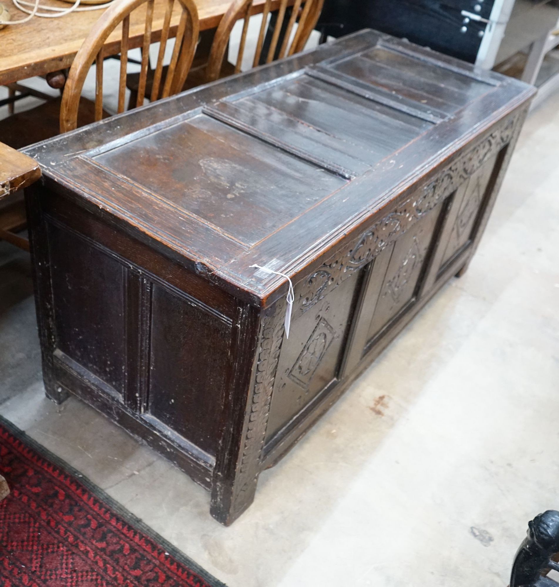 An 18th century carved oak coffer, length 133cm, depth 57cm, height 64cm